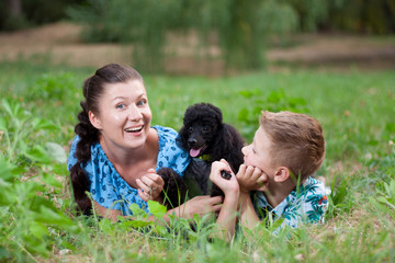 mother with son and a black poodle