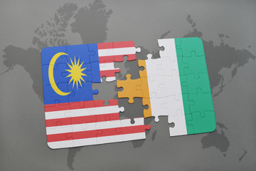 puzzle with the national flag of malaysia and cote divoire on a world map background.