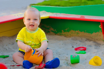 Toddler Boy playing in a sandbox