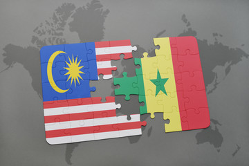 puzzle with the national flag of malaysia and senegal on a world map background.