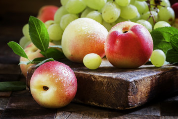 Grapes and nectarines, vintage wooden background, selective focu