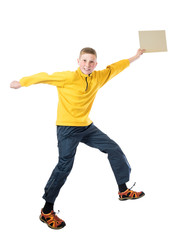 Young red-haired boy in a yellow jacket jumping with arms outstretched and holds in his hand plate on a white background