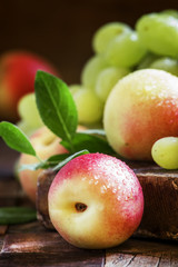 Grapes and nectarines, vintage wooden background, selective focu