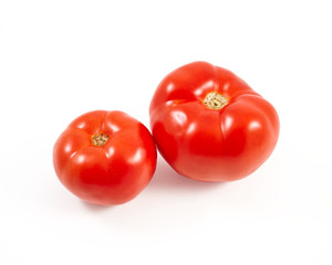 A tomato. Red tomato on a white background. Harvest vegetables. Autumn harvest. Red, juicy, ripe tomato.