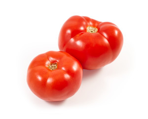 A tomato. Red tomato on a white background. Harvest vegetables. Autumn harvest. Red, juicy, ripe tomato.