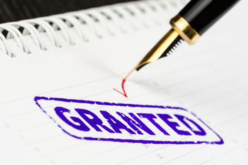 Macro shot of stamp granted