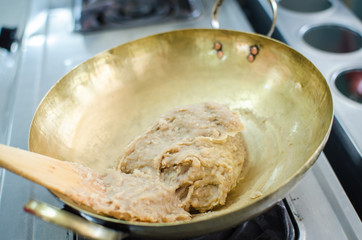 crushed taro in brass pan prepare for making thai dessert