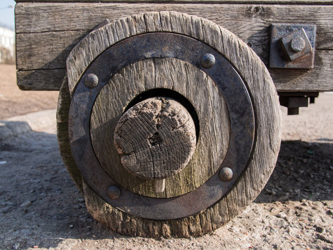 Close up of an old wooden wheel with an iron rim that suited in the hub of the wooden carts