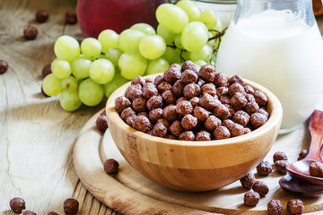 Breakfast: chocolate balls, fresh cows milk, grapes and peaches,