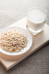 Plate with dry cereal and a glass of milk