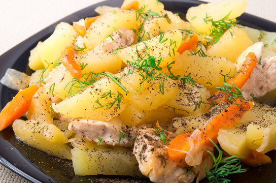 Slices of stewed potatoes, chicken, carrot and onion