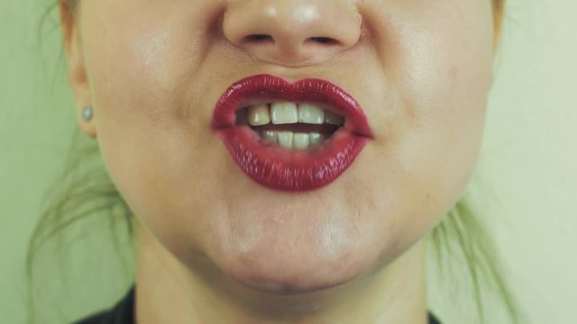 Woman with red pomade on lips sing song in front camera. Mouth. Teeth. Face. Close up