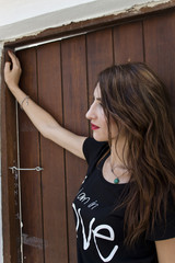 Young Russian girl  Looking the Further on the wooden door in outdoor izmir,turkey