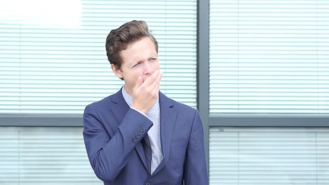 Yawning Gesture by Tired Young Businessman