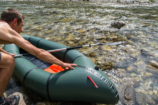 Man packraft ready to go