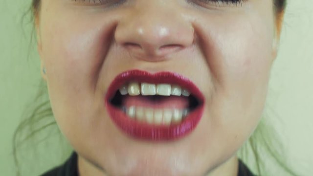 Woman with red pomade emphatically sing song in front camera. Pronounce words. Close up