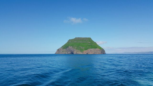 Alone green Faroe island L&iacute;tla D&iacute;mun in the Atlantic ocean