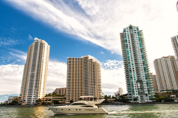 Downtown Miami along Biscayne Bay with condos and office buildings, yacht sailing in the bay