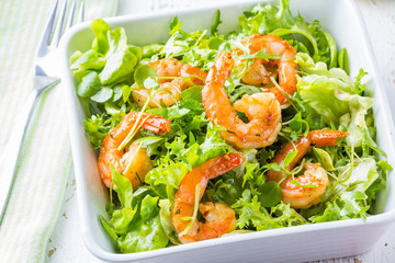 Seafood shrimp lettuce salad on white plate