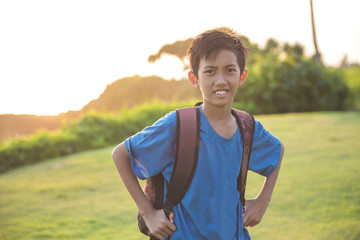 happy boy carrying bagpack smiling