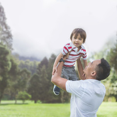 Father with his baby boy in park.