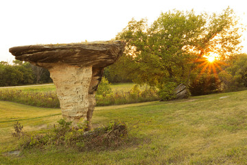 Rock shaped as a mushroom in glowing sunset 