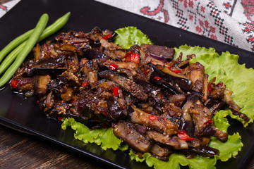 Baked eggplant with onions, garlic, red hot chili pepper and walnuts