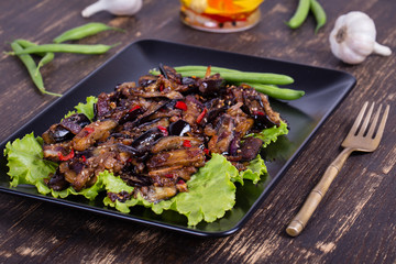 Baked eggplant with onions, garlic, red hot chili pepper and walnuts