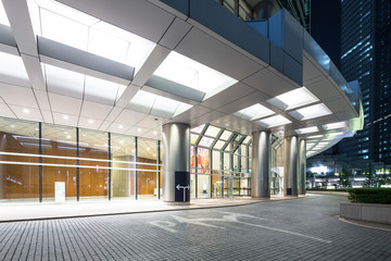 Fototapeta na wymiar modern buildings in tokyo at night from empty footpath