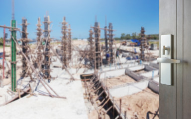 opened wooden door to construction site for housing project