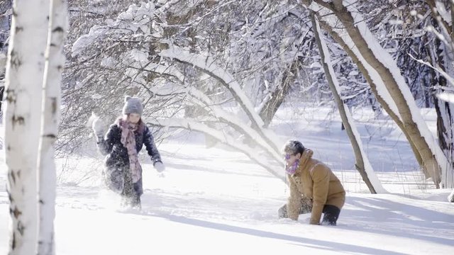 happy couple have a snowball fight