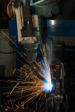 Robot welding automotive part in factory