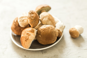 plate with fresh white mushrooms
