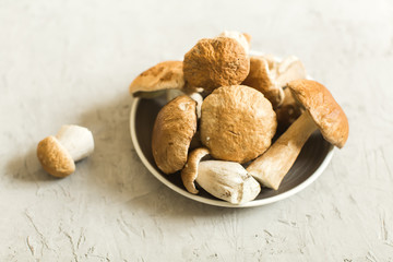 plate with fresh white mushrooms