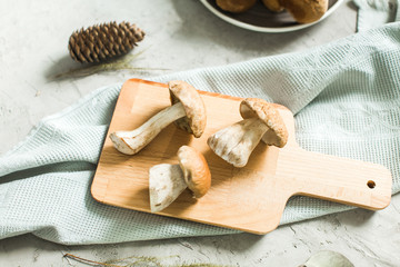 fresh white mushrooms on wooden board