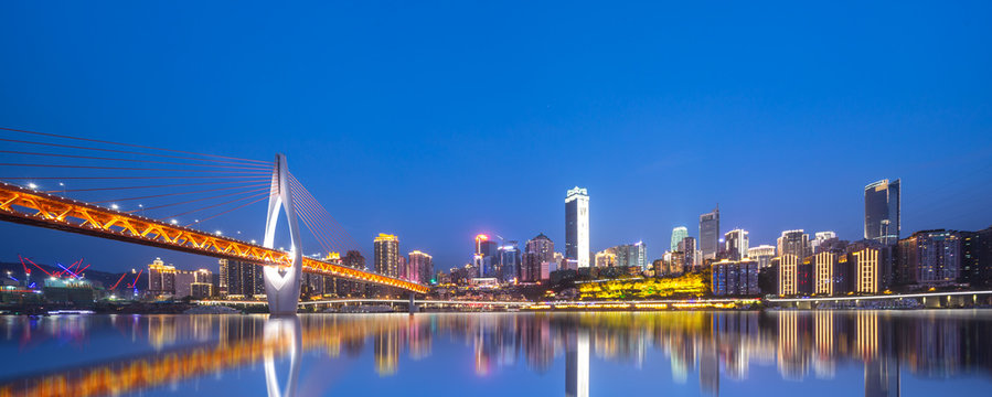 cityscape and skyline of chongqing from water at night