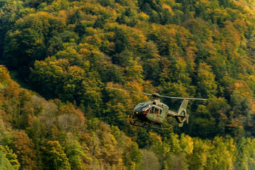 Fototapeta na wymiar AXALP, SWITZERLAND - OCTOBER 11: Swiss Airforce Eurocopter 635P2+ during training before Axalp Swiss Air Force Live Firing Demo on October 11, 2011 in Axalp, Switzerland