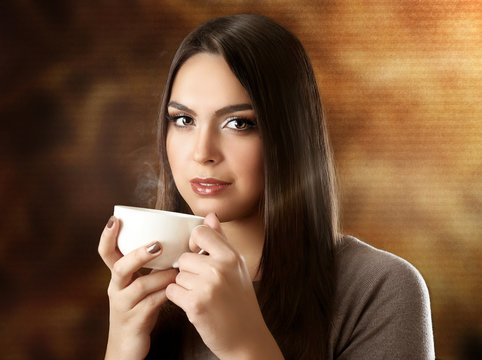 Portrait of pretty woman drinking coffee on blurred background