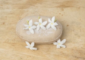 herbal soap with flower on wooden background