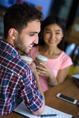 Portraot of romantic couple having date in restaurant or cafe. Happy man and woman drinking coffee and communicating about life.