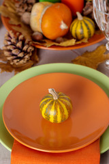 Thanksgiving dinner. Seasonal table setting with autumn leaves,