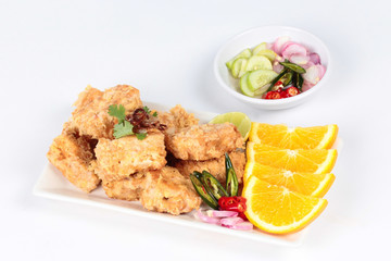 Fried tofu nuggets with minced shrimp and pork on white background.