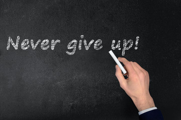 Never give up text on black board