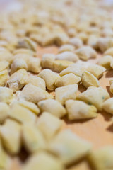 Fototapeta na wymiar Uncooked homemade gnocchi on cutting board - homemade pasta