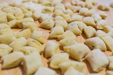Uncooked homemade gnocchi on cutting board - homemade pasta