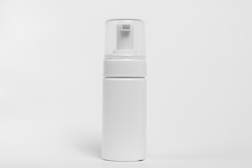 White plastic bottle with spray on white background.
