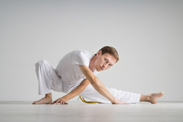 Young man doing stretching exercises