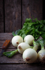 Raw fresh onions on wooden background