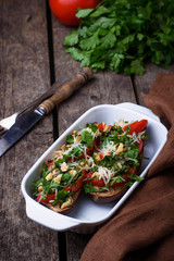 Baked eggplant with cheese, tomato, herbs and nut.
