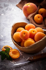 Naklejka na ściany i meble Sweet apricots on wooden background